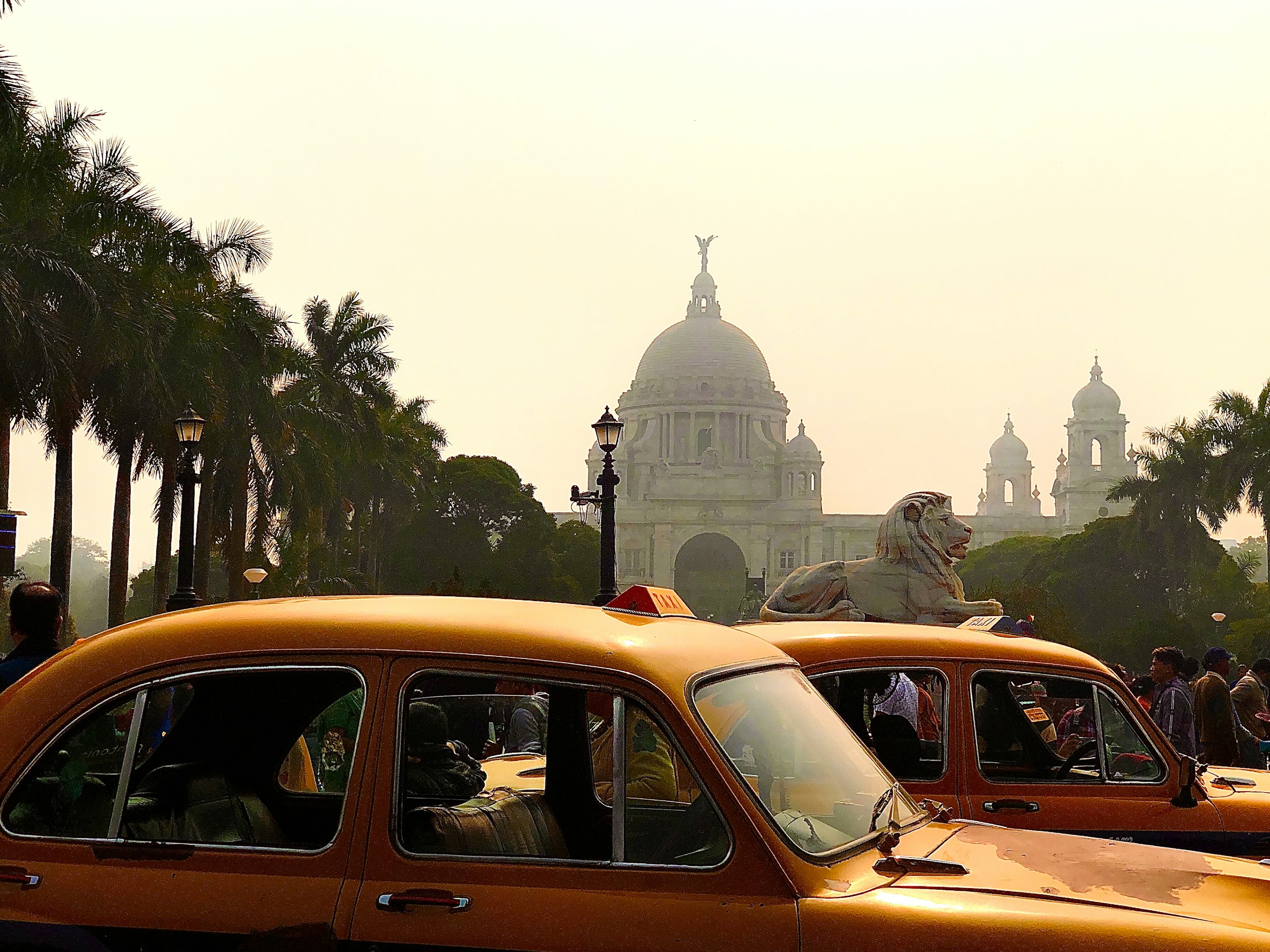 Kolkata's iconic yellow taxis in front of the Victoria Memorial